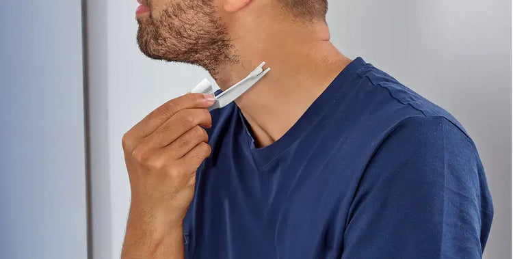 Man using Scholl Freeze Away Skin Tag Remover on his neck